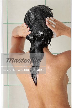 Young woman in shower washing her hairs