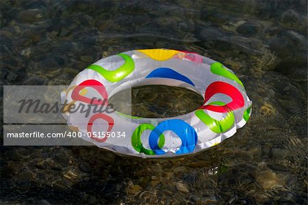 Inflatable ring floating on the sea, transparent clear water