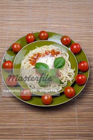 Pasta with tomato sauce basil and grated parmesan