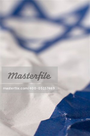 abstract conceptual photo of israel flag, david star blurred in background, only small portion in focus