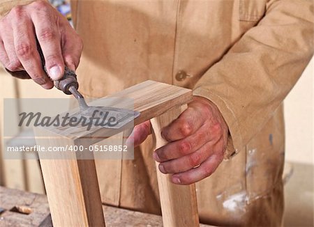 detail of caucasian carpenter at work with tool