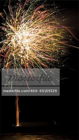 colorful fireworks display with reflection in water