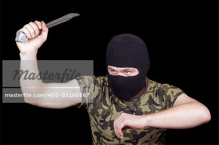 The murderer with a knife in a black mask