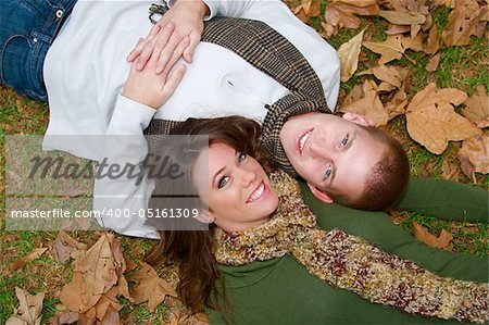 Young couple in an autumn forest picnic area