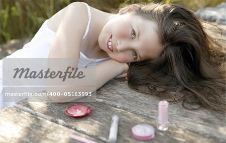 beautiful young girl portrait with make up set outdoors, at the park