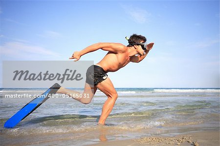 Funny young man ready for fun at sunny beach