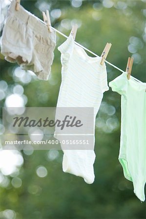 Child clothes drying on a clothes line outside