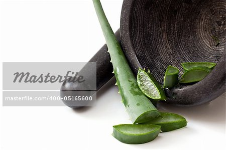 preparing aloe on a black old mortar and pestle