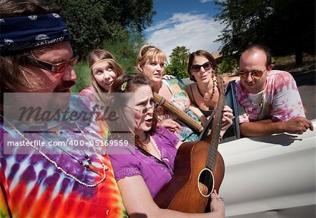 Group of hippies with female guitar player