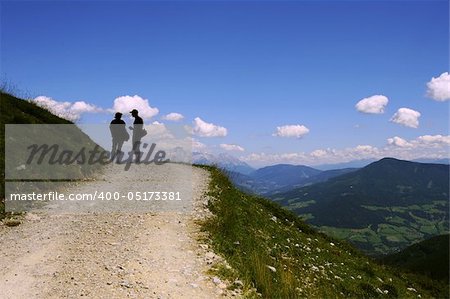 Hikers against sky on a road in the Austrian Alps