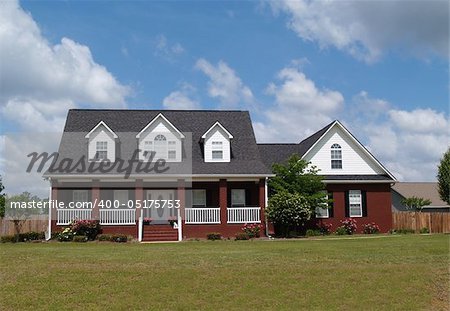 Two story residential home with with board siding on the facadeTwo story residential home with brick facade.