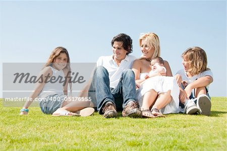 Smiling family relaxing on grass