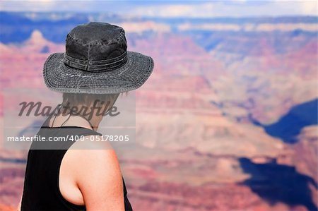 Female hiker looking over the ridge of the Grand Canyon