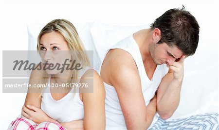 Worried woman after having an argument with her boyfriend in bed