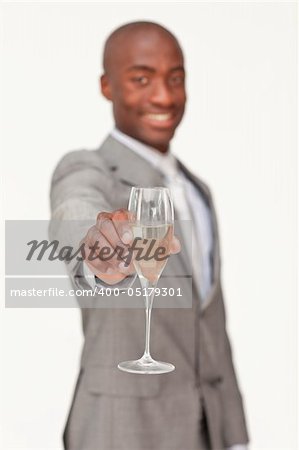 Ethnic businessman celebrating a success with champagne against white