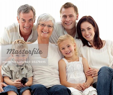 Happy family watching television on sofa at home