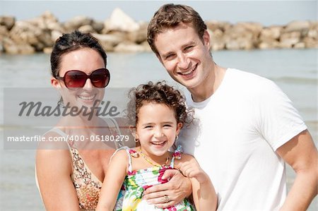 Young couple embracing and enjoying with young daughter