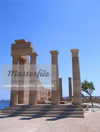 Ruins of ancient Greek temple with columns in summer day. Lindos, Rhodes