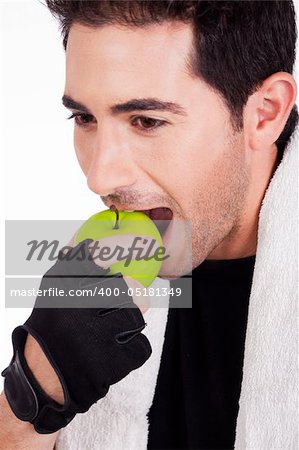 Fitness man having green apple,indoor studio