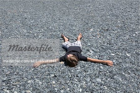Boy Lying Down on the Ground, Corsica, France