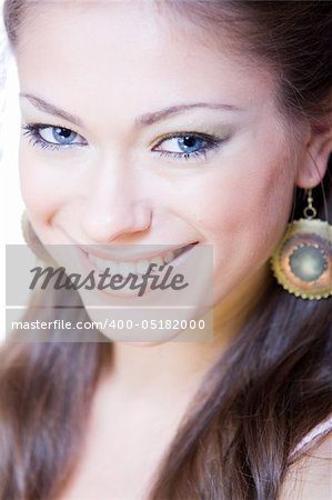 closeup portrait of attractive smiling young woman with ear-rings