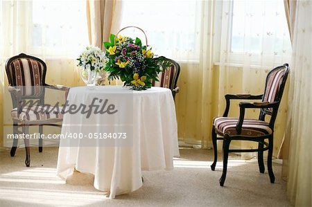 A view of a  banquet table  and a colorful flower centerpiece.