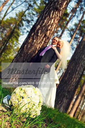 Wedding bouquet, newly-weds look at a bouquet