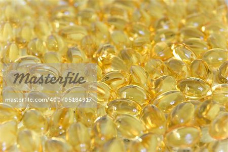 Background of yellow omega-3 oil capsules