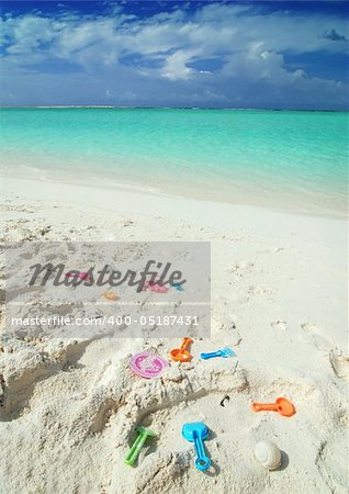 Colorful child toys laying on the beach in the Maldives