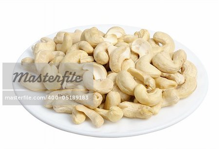 Cashew nuts in a white plate on a white background, isolated
