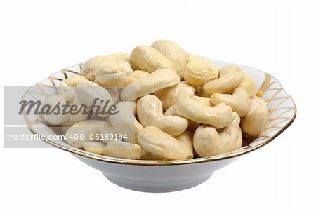 Cashew nuts in a white plate on a white background, isolated