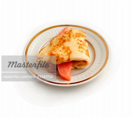 Salmon with  pancake on plate isolated on white.
