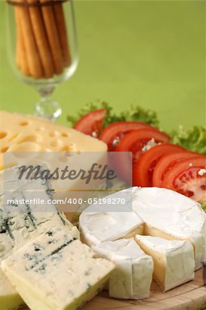 Cutting board with different kinds of cheese