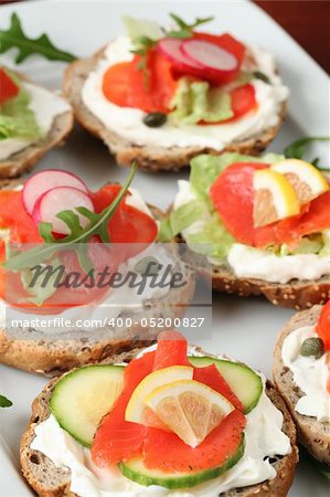 Delicious appetizers with smoked salmon and vegetables