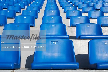 A field of blue stadium seats.