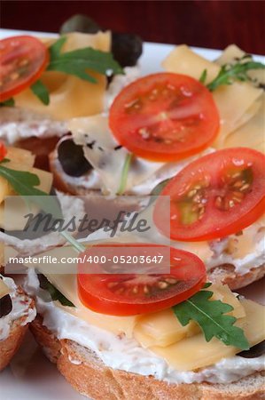 Delicious appetizers with cheese, cream cheese spread and vegetables