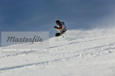 skier free ride downhill at winter season on beautiful sunny day