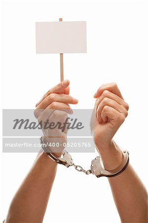 Handcuffed Woman Holding Blank White Sign Isolated on a White Background - Ready for Your Own Message.