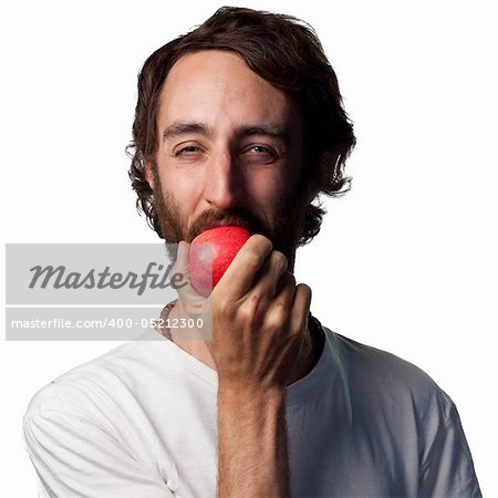 Young man eating a fresh apple