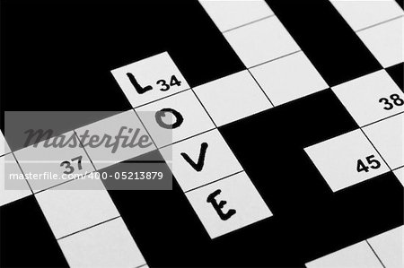 A hand written word love in a crossword puzzle