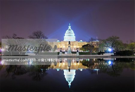 Capitol hill building at night illuminated with light with lake reflection, Washington DC.