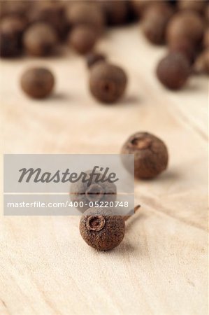 Closeup of allspice on a wooden table. Shallow dof, selective focus