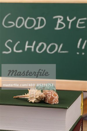 Sea shells on a pile of books and a chalkboard in background with text: Good bye school