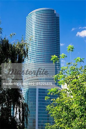 High skyscraper and green tree in Moscow city