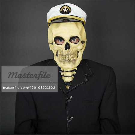 The man - a skeleton in a naval cap on a dark background