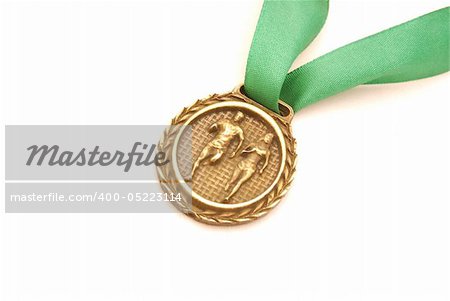 A gold medal with green ribbon for runners. Image isolated on white studio background.