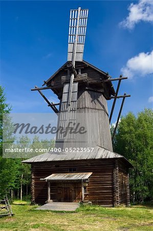 Old windmill under blue sky