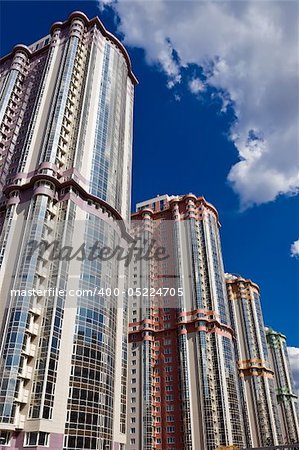 High modern apartment buildings under blue sky