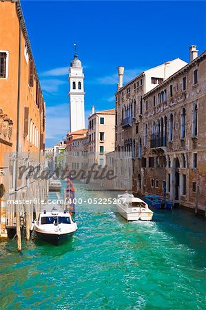white boats in a canal in Venice, Italy