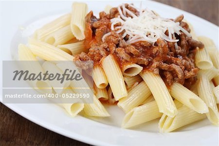Penne pasta with bolognese sauce and cheese